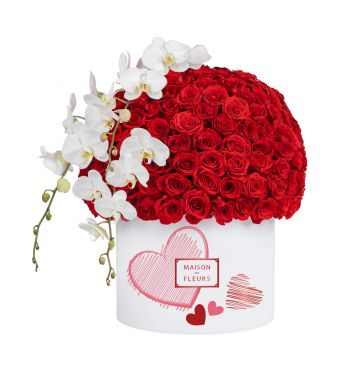 This Luxurious limited edition round 40 cm Valentine’s box arranged with a dome of finest red roses and accented with 3 white orchid stems